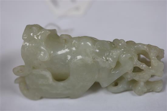 A Chinese archaistic white jade rhyton and a spinach green jade vase, 18th/19th century, H. 11cm and 8.5cm